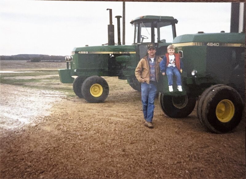 Father and son with John Deere tractors at Fisher Farms